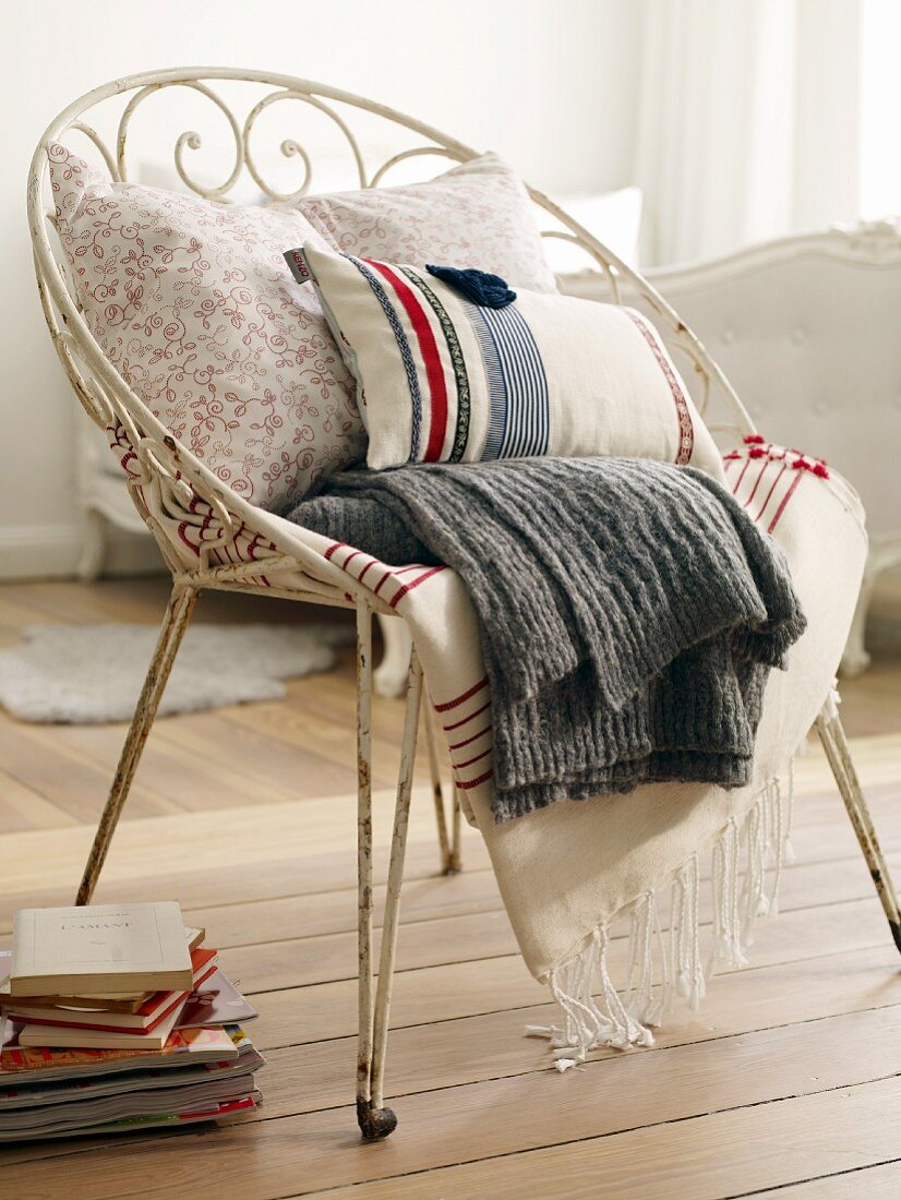 Cushions and blankets on metal chair