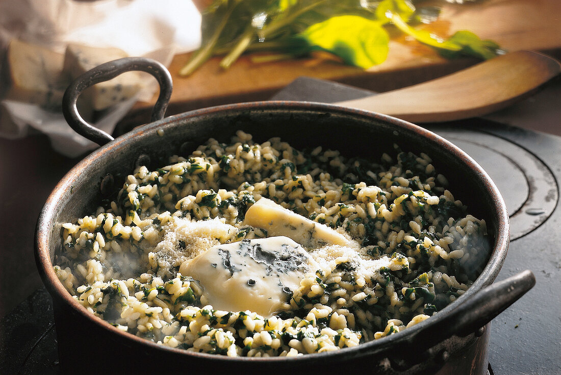 Risotto with spinach, onion, garlic and parmesan in wok