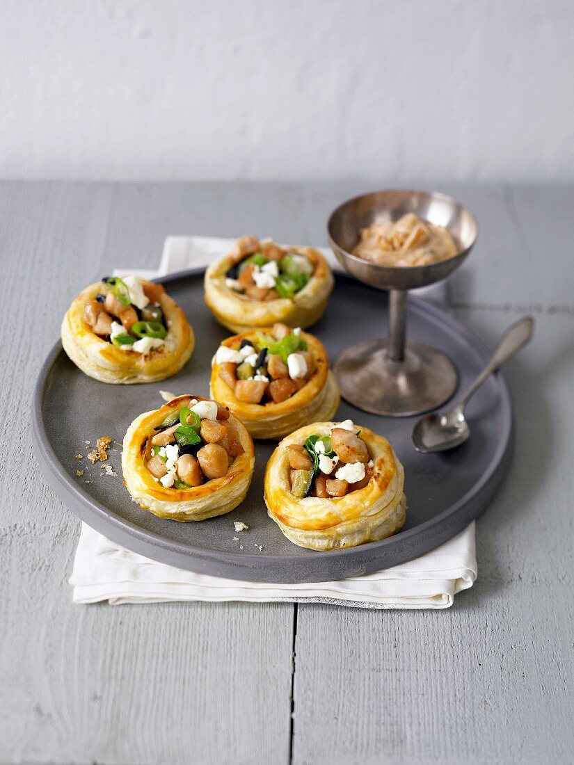 Puff pastry vol-au-vents filled with chicken, aubergine, feta and a peanut dip