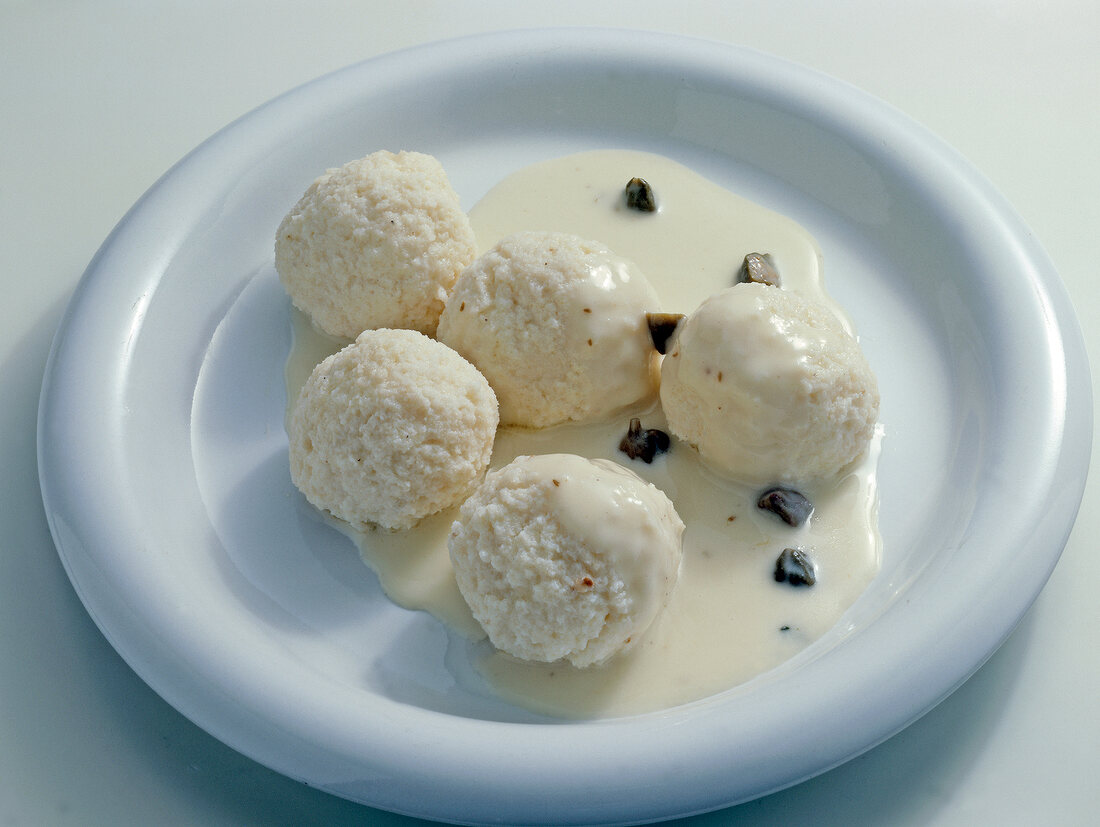 Close-up of fish dumplings with sauce on plate