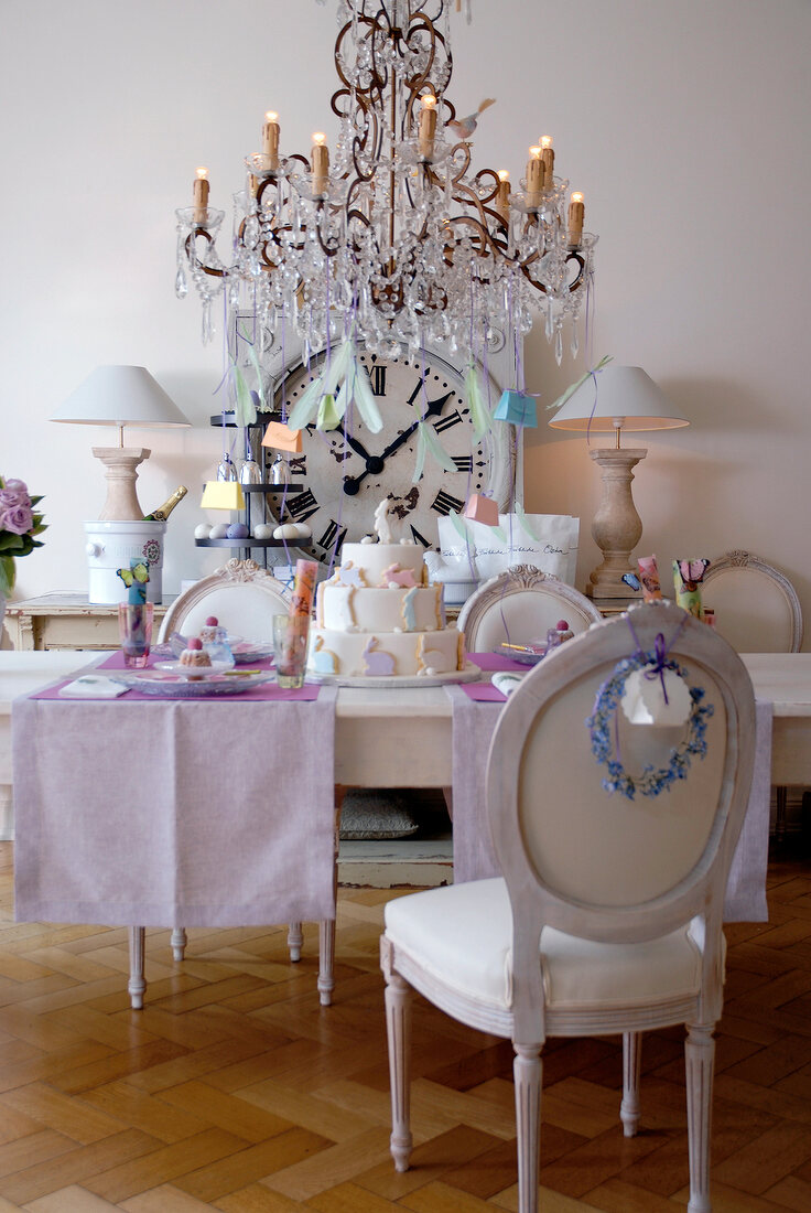 Festively decorated table in creme with chandelier on top