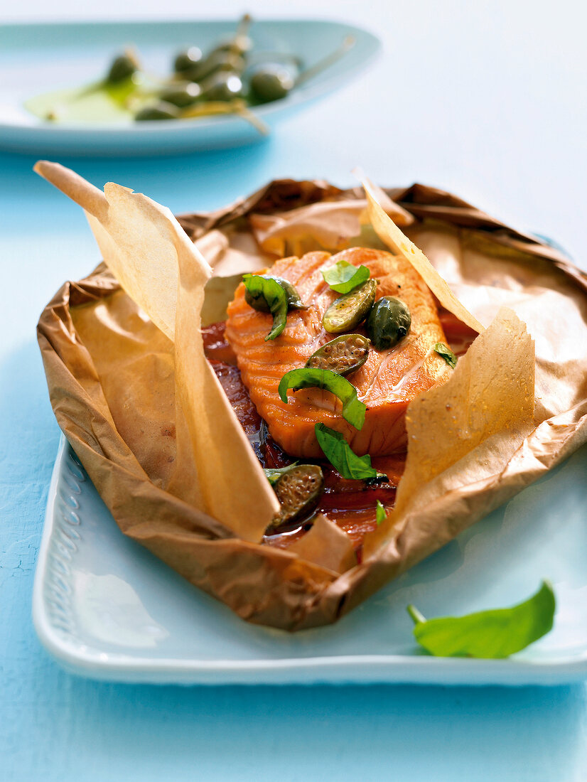 Close-up of parcel with salmon fillet and tomato