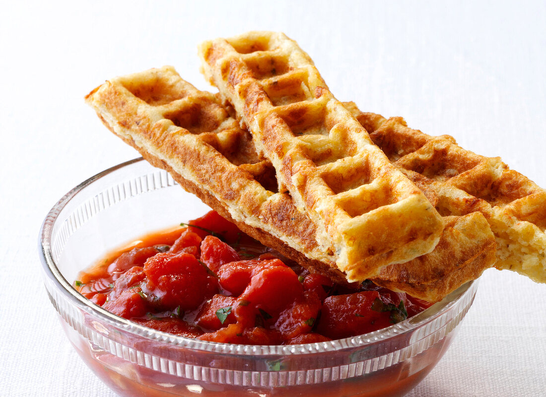 Cheese waffles with tomato dip in bowl