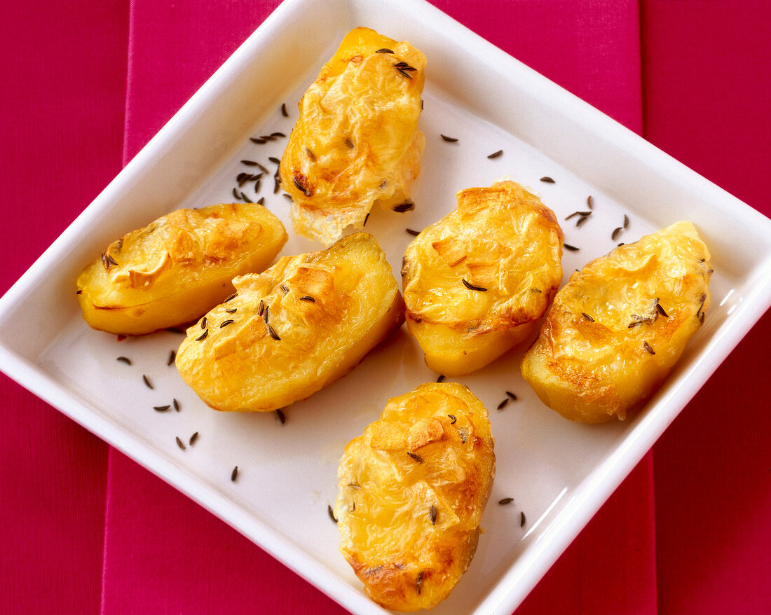Cheese potatoes with cumin in serving dish