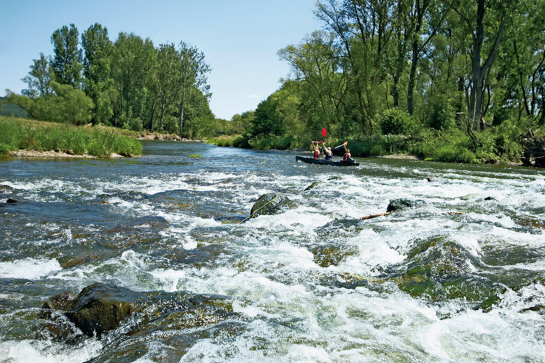 People canoeing in river at Keller Edersee National Park in Hessen, Germany