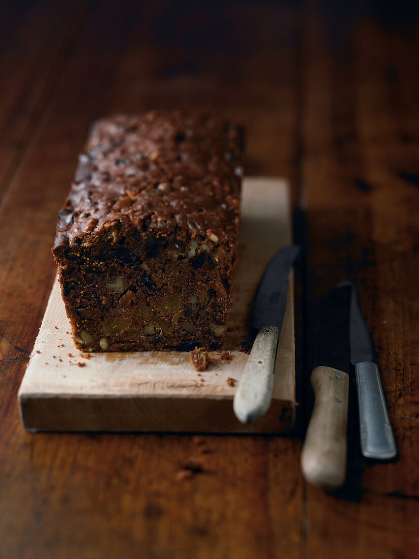 Homemade fruitcake on wooden platform