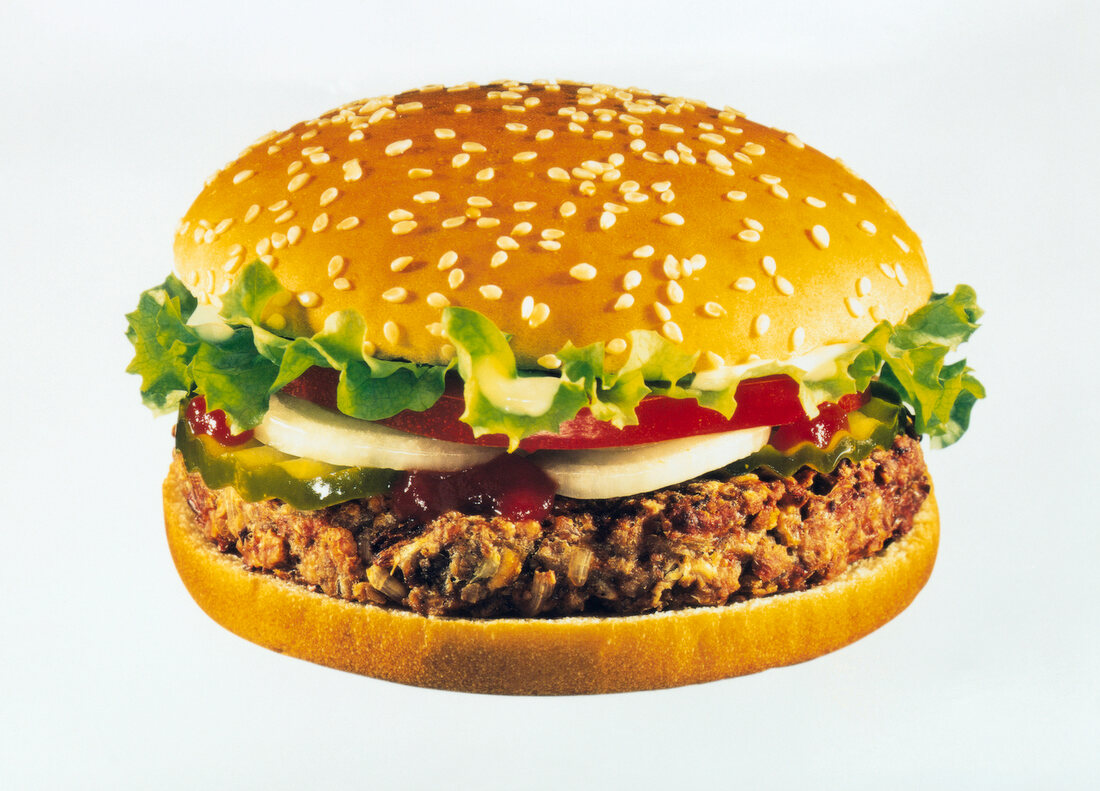 Vegetable burger with lettuce, tomato, onions, cucumbers, ketchup and sesame seed