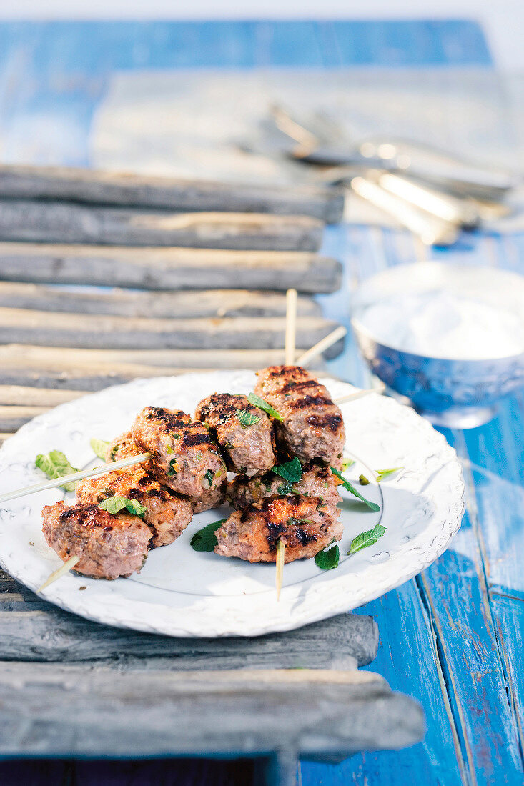 Lamb meatballs with dried apricots in skewers served with mint yoghurt