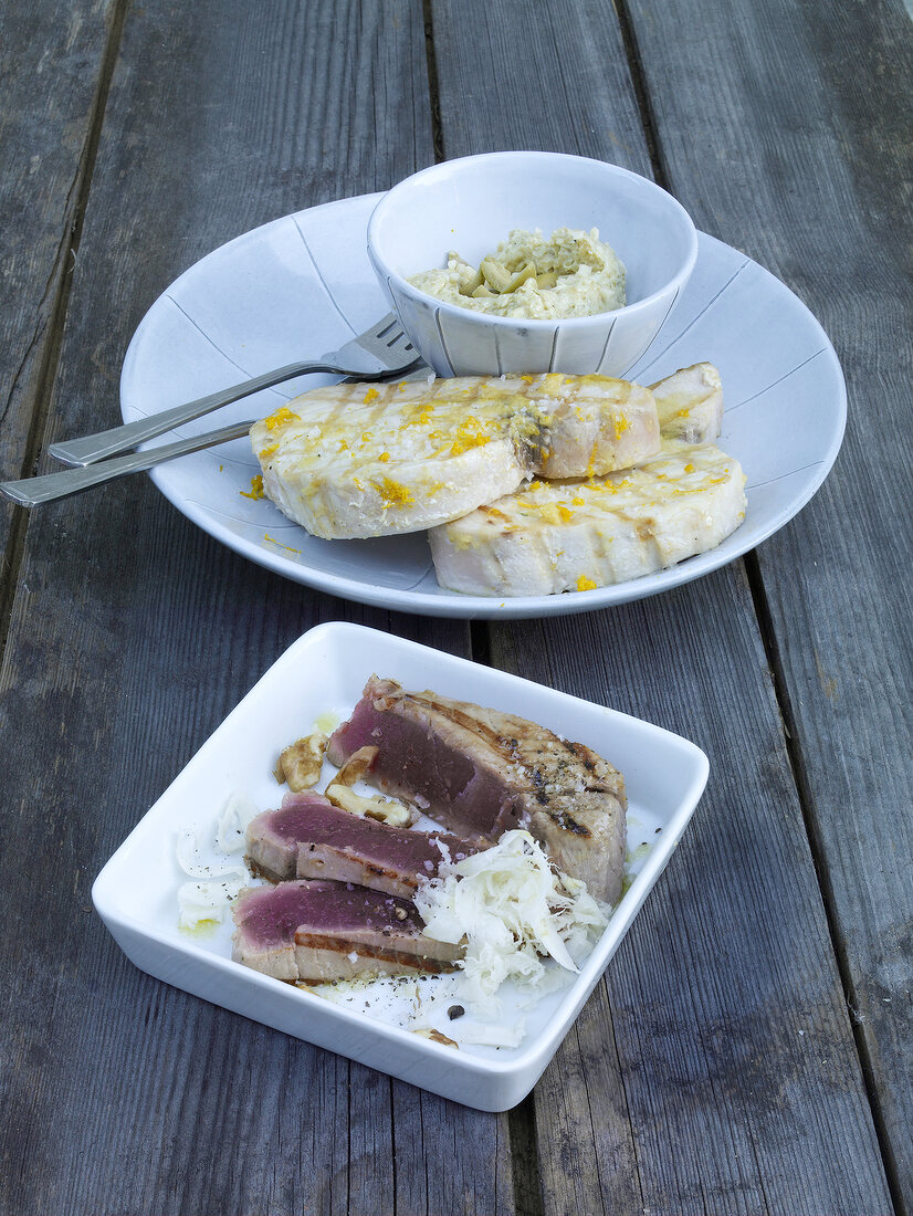 Two plates of tuna with horseradish and swordfish with olive and butter