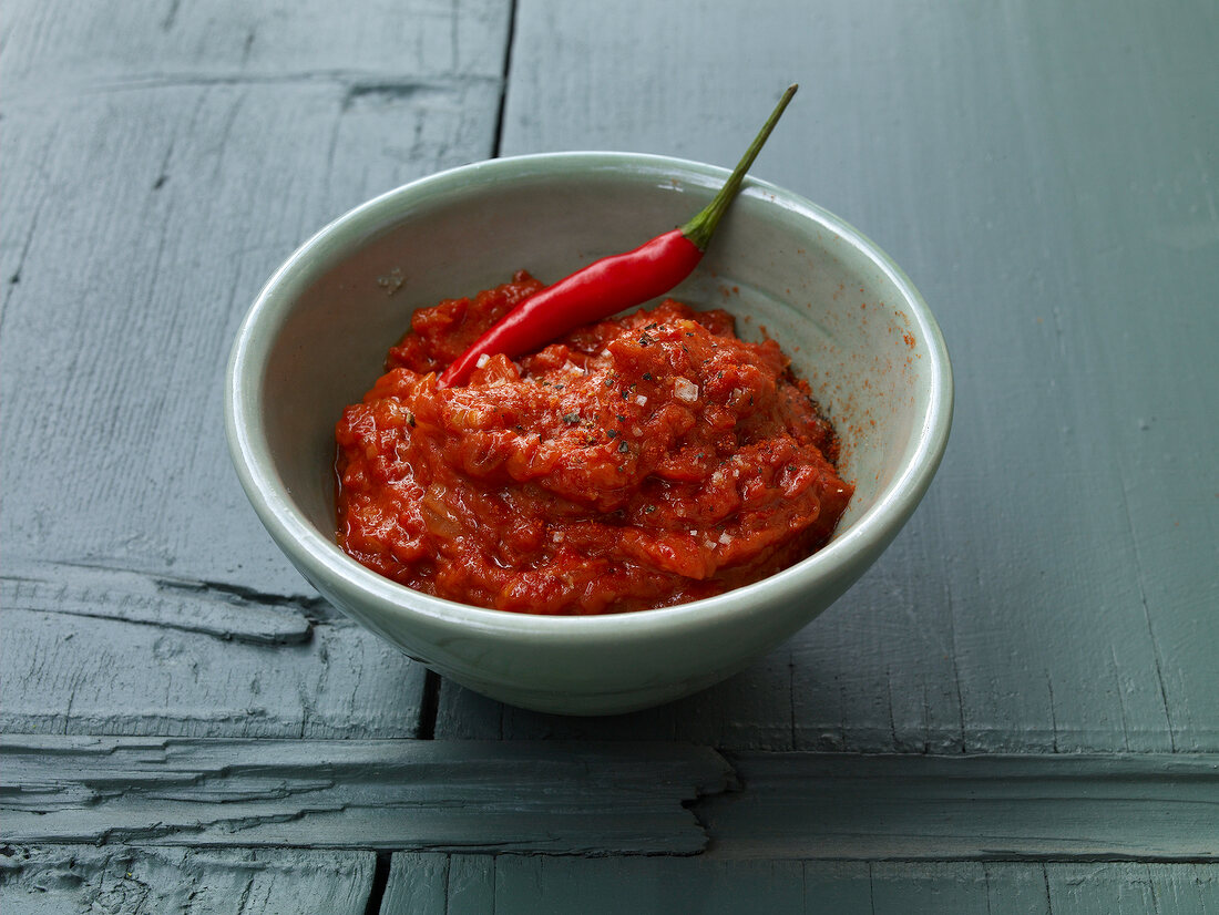 Bowl of ajvar sauce and whole red pepper