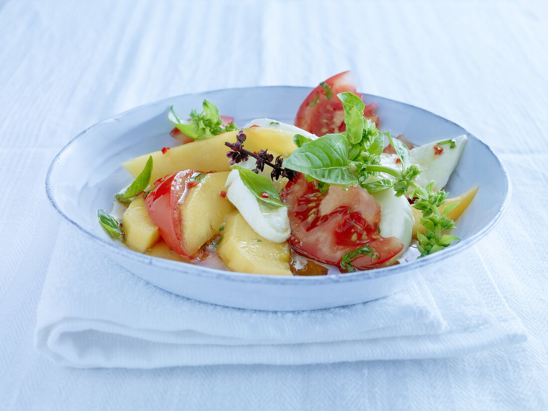 Mango and tomato salad in bowl