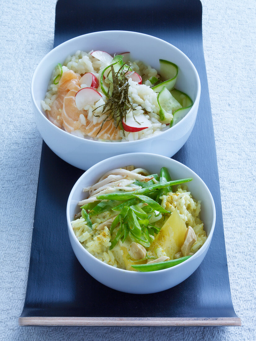 Sushi salmon salad and curried rice salad with turkey in bowl