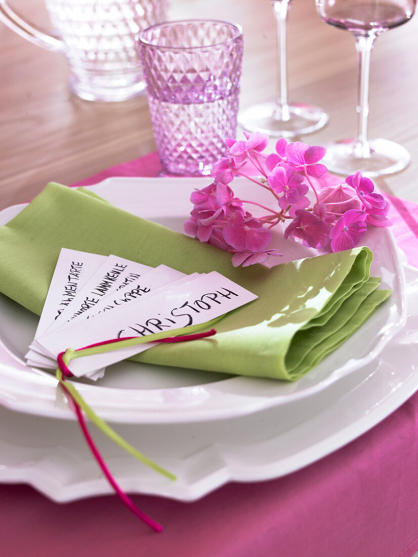 White crockery set on pink and green napkin