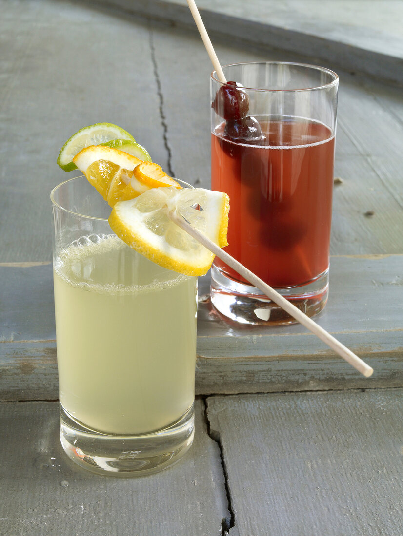 Two glasses of lemonade with fruit skewers