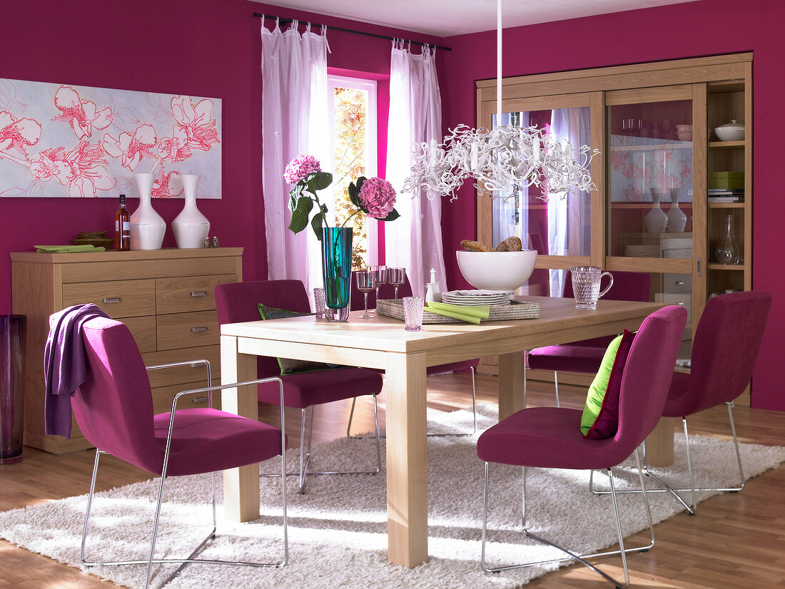 View of pink dining room with wooden furniture