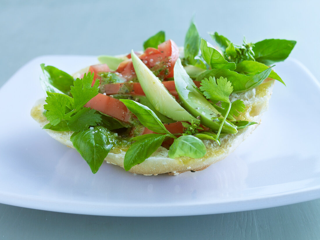 Tomato and avocado salad in pita bread, coriander