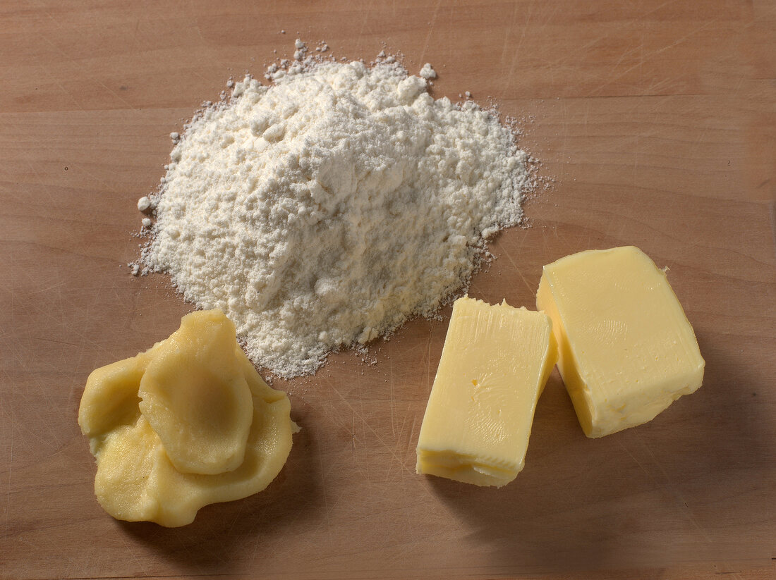 Flour and butter on wooden board