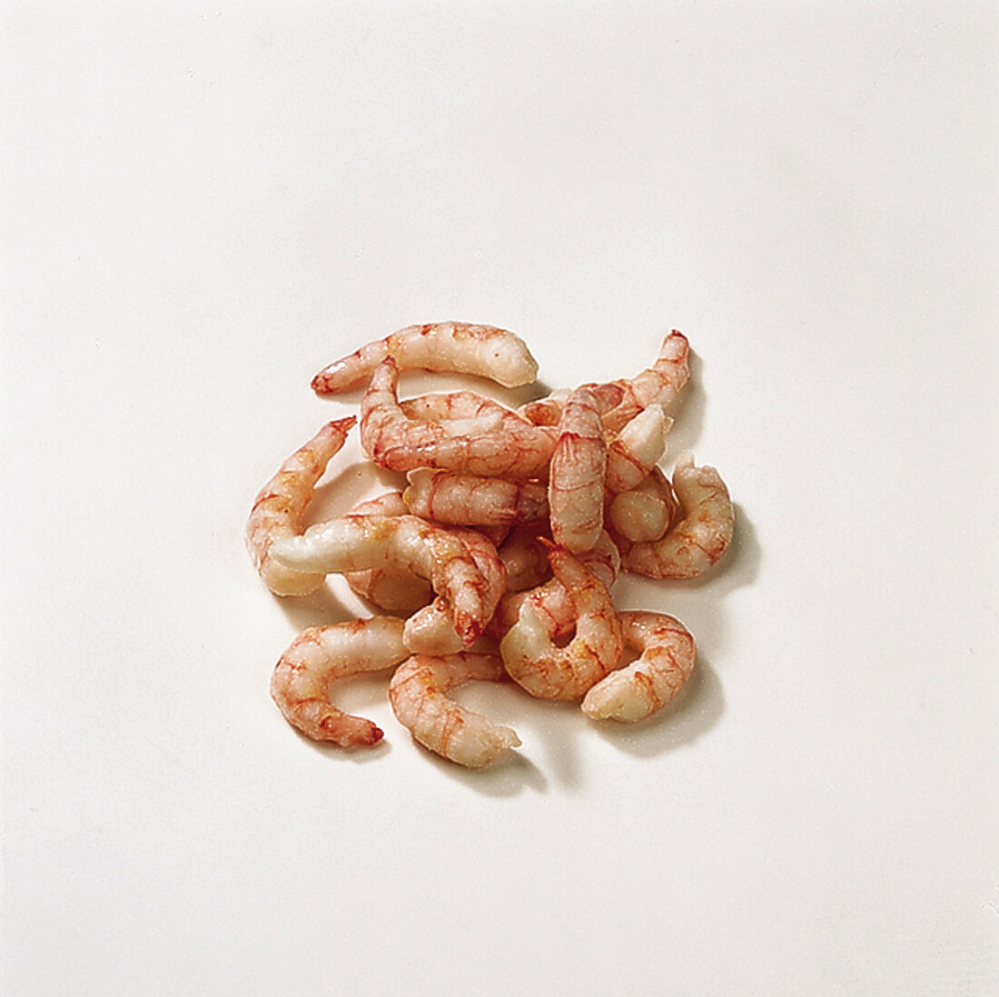 Peeled and cooked shrimps on white background