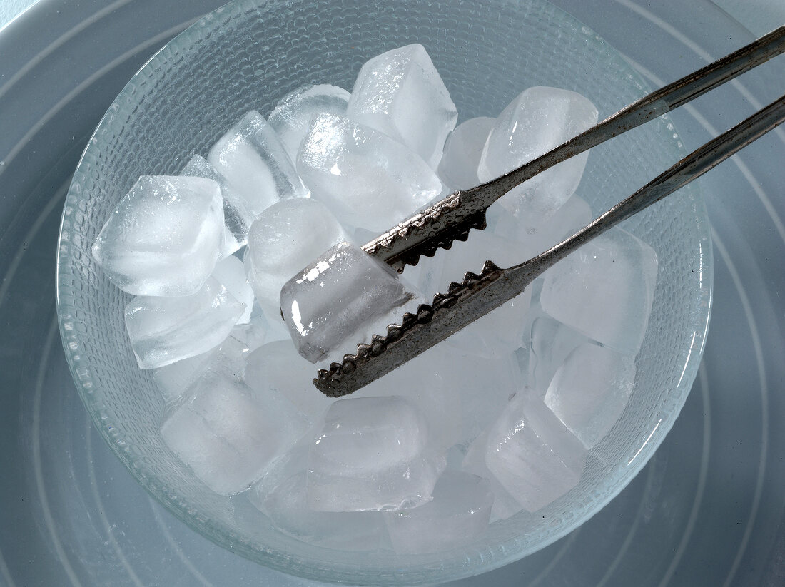 Bowl of ice cubes and tongs