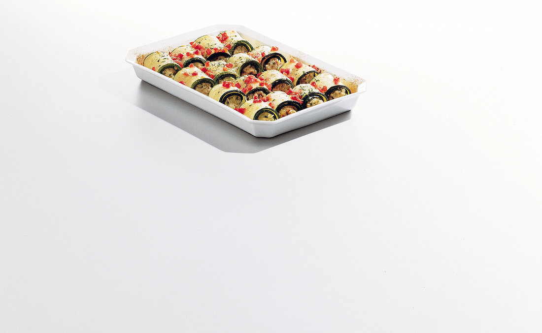Squash and zucchini rolls with vegetable and rice in tray, copy space