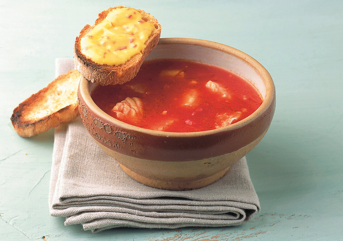 Spicy fish soup gratin with cheese toast in bowl