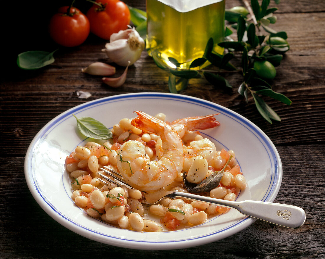 White beans salad with lukewarm shrimp on plate