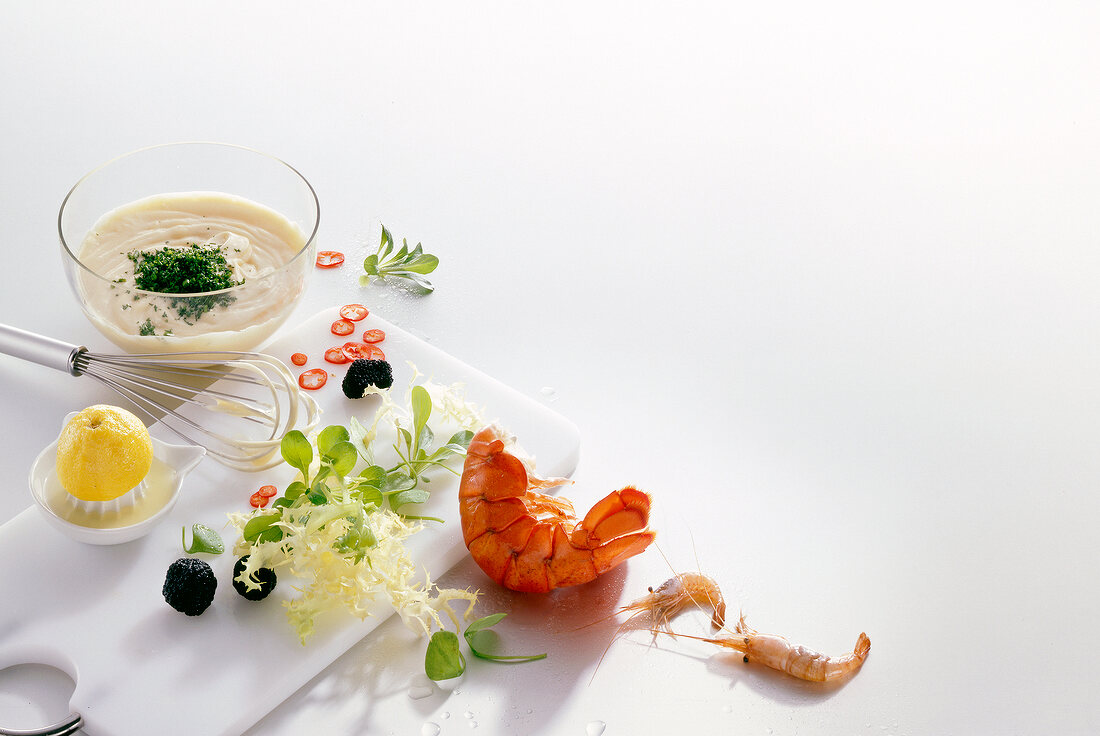 Shrimp, lobster tail, lemon, lettuce, mayonnaise, truffle and chilli on white background