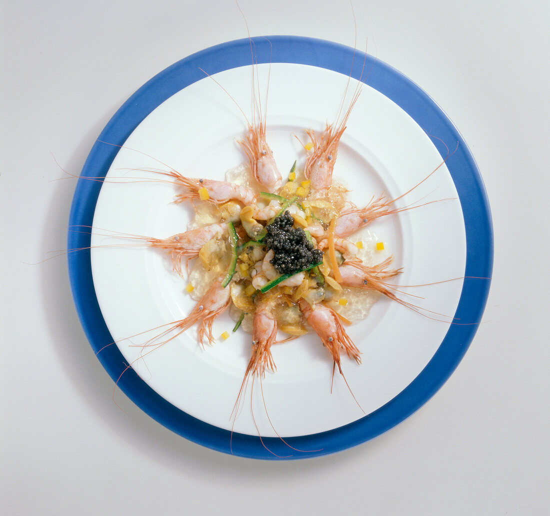 Shrimp with shells, jelly, caviar, carrots and zucchini on plate