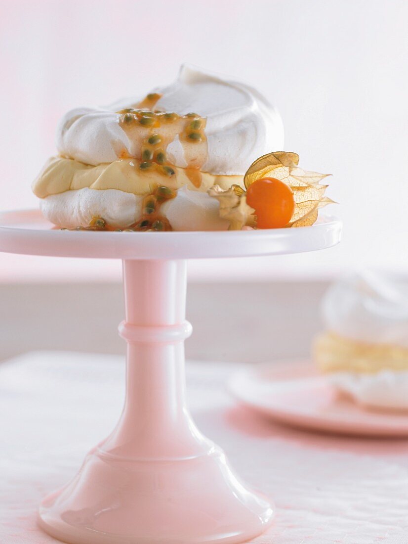 Meringue with passion fruit cream on a cake stand