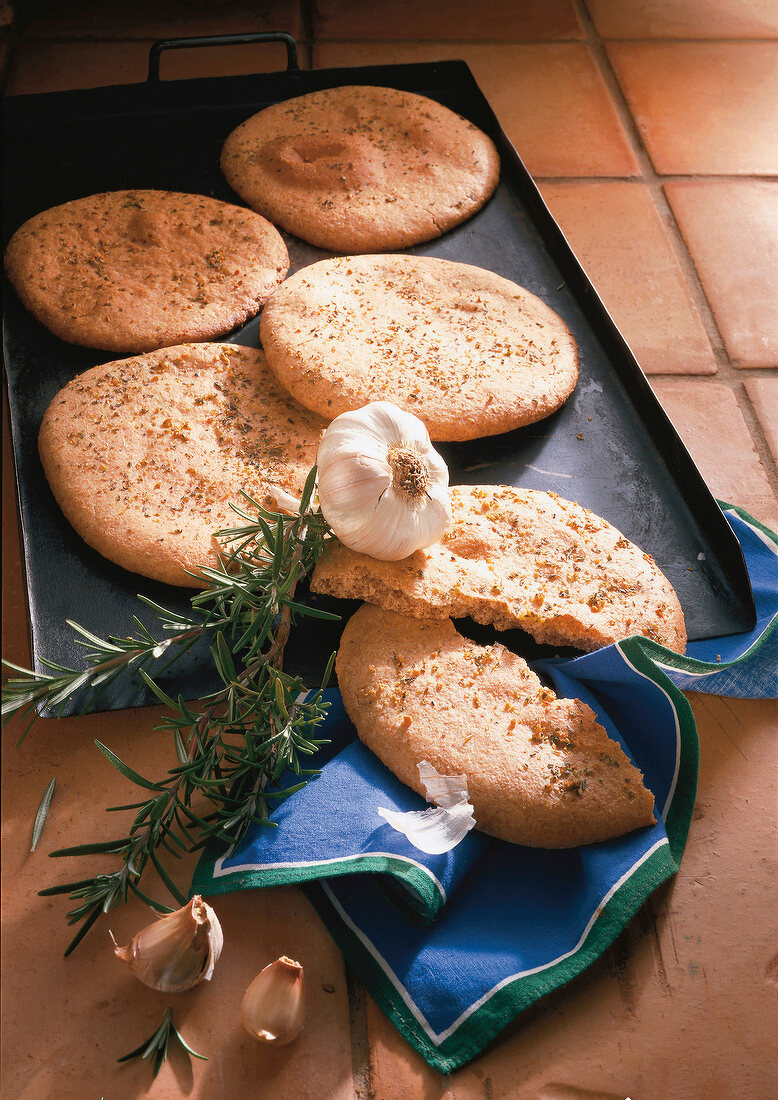 Five herbal breads with garlic and rosemary in baking tray