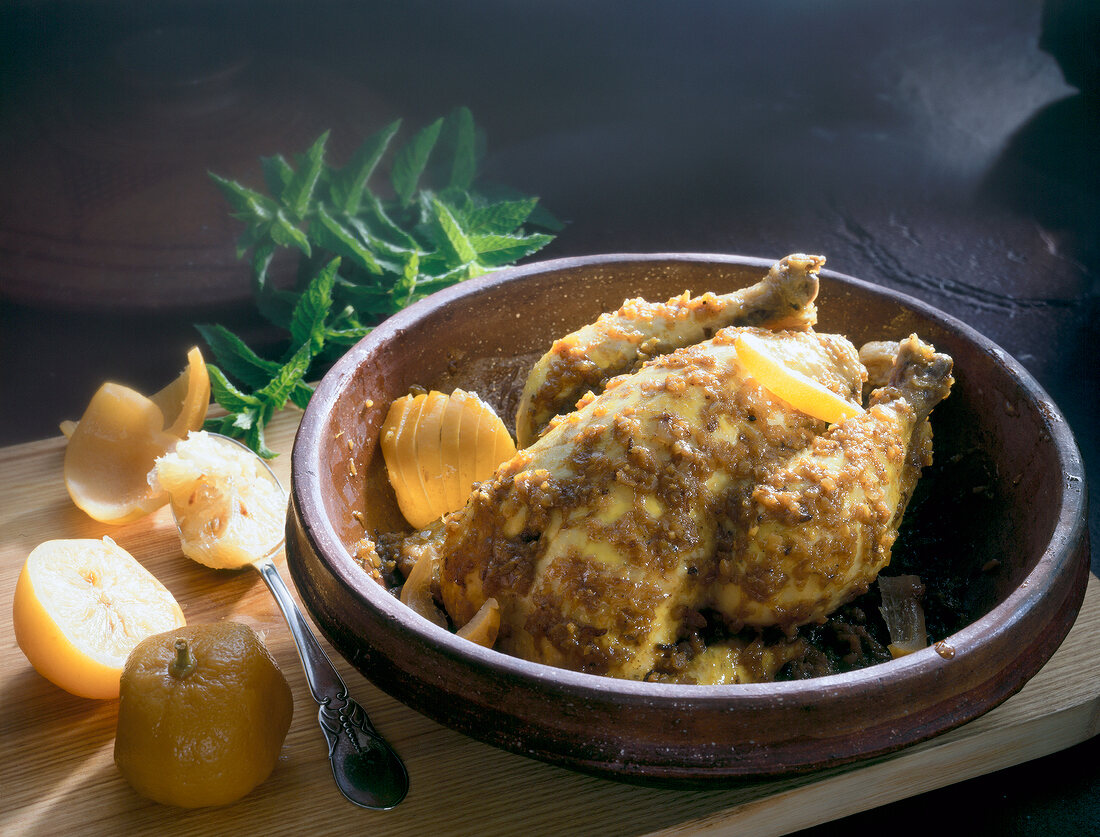 Close-up of spiced lemon chicken in clay bowl