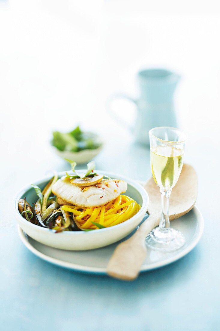 Coley with eggplant and saffron noodles in bowl