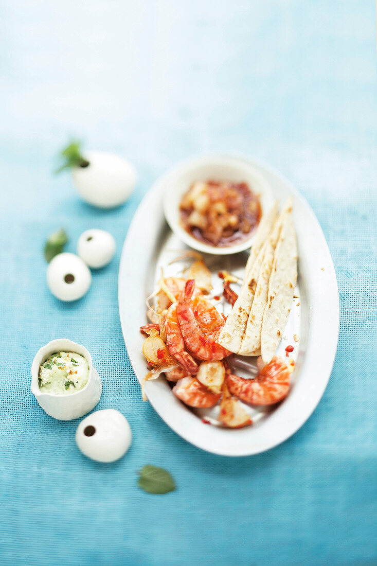 Fried prawns with avocado and pear chutney on plate