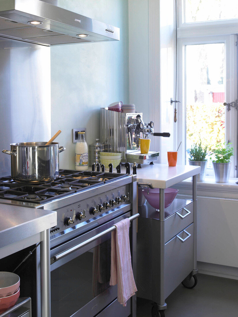 Large stainless steel gas cooker, roll top desk and espresso machine in kitchen