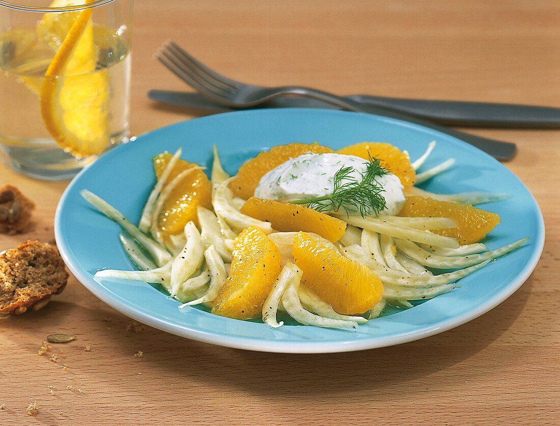 Salad with fennel, orange, dill and sour cream on plate