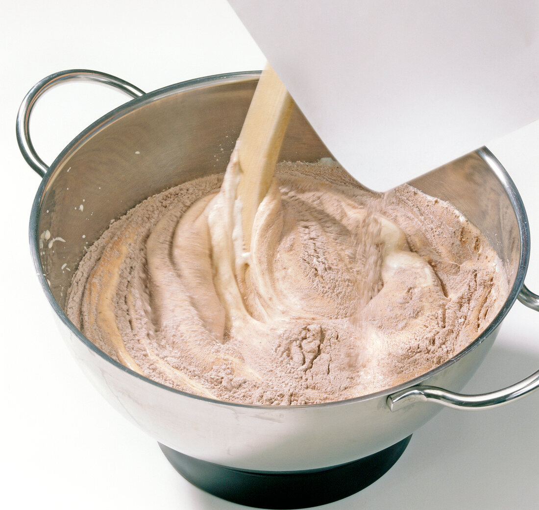 Close-up of cocoa dough being stirred in pan for preparation of chocolate, step 3