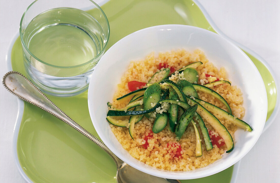 Vegetable couscous with zucchini and asparagus in bowl