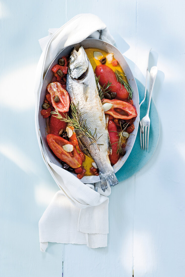 Sea bass with rosemary and tomatoes, overhead view