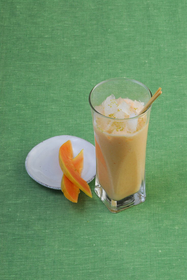 Glass of papaya smoothie with ice cubes … – Buy image – 10208327 ❘  
