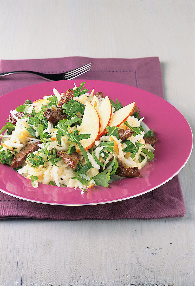 Close-up of celery salad with duck breast and apples in dish