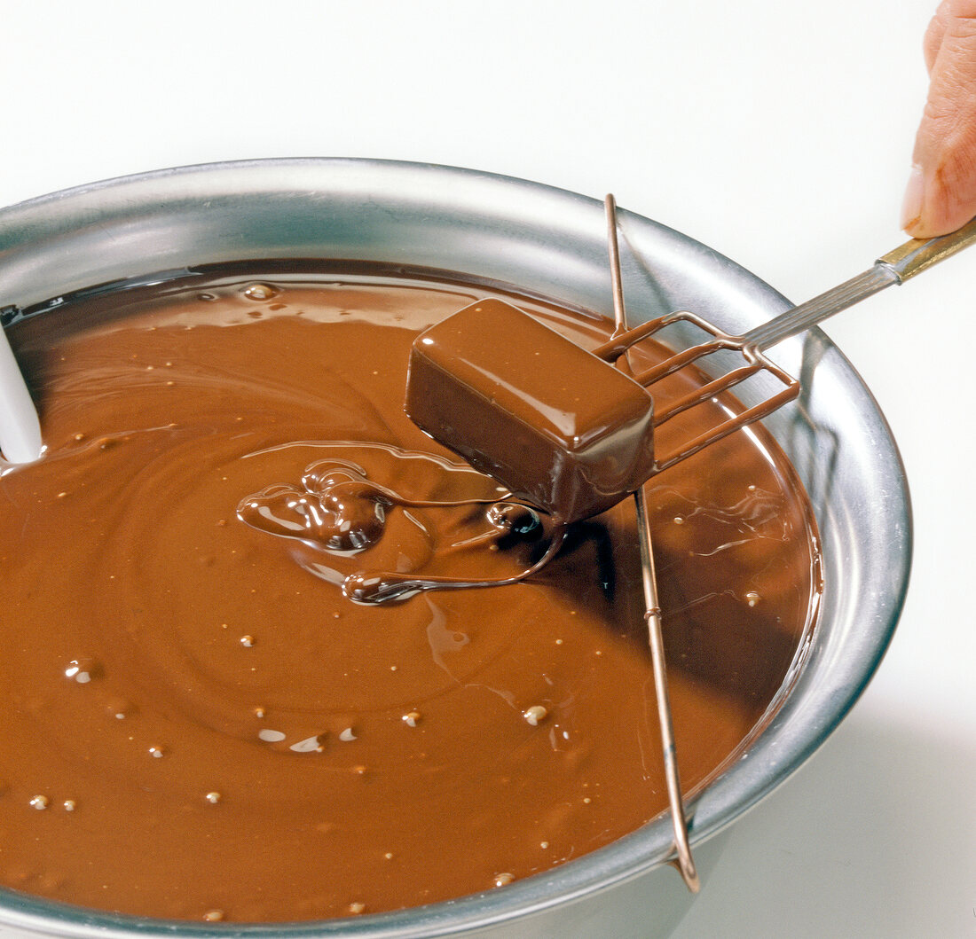 Close-up of extra chocolate being wiped on bowl rim, step 3