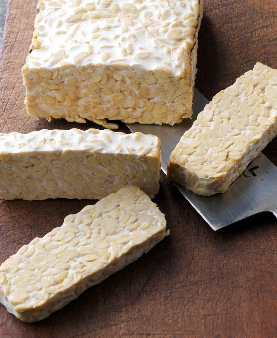 Close-up of slices and block of tempeh made from soybeans