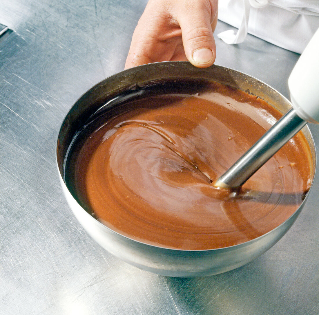 Close-up of chocolate-cream mixture being mixed with blender