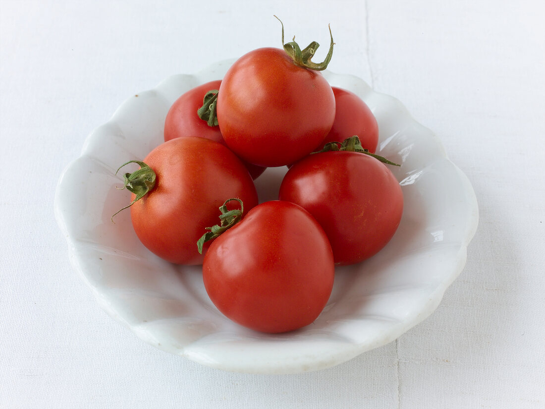 Close-up of bowl of small red cherry tomatoes in it