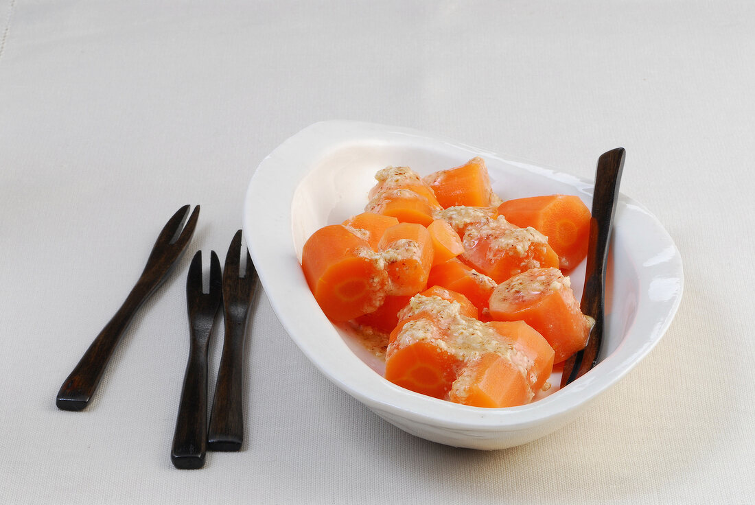 Close-up of carrots with sweet and sour dip in bowl