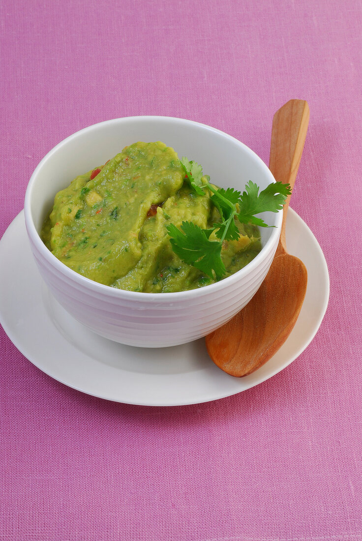 Bowl of green guacamole in serving dish