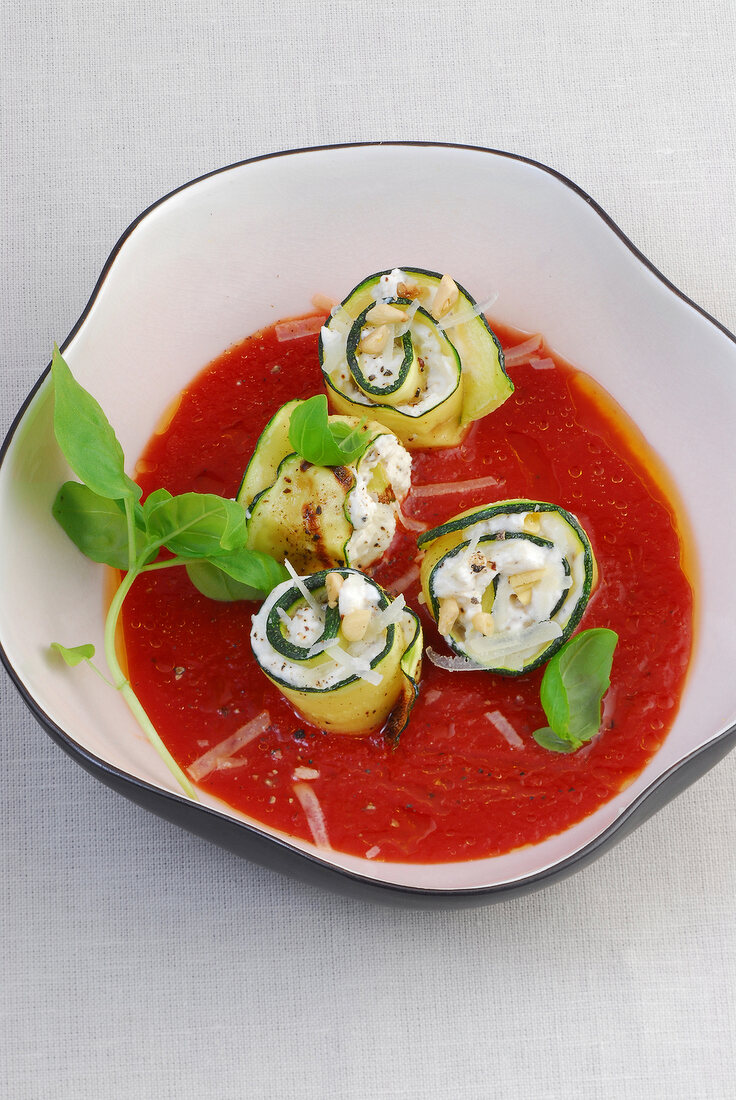 Close-up of zucchini rolls with tomato gravy