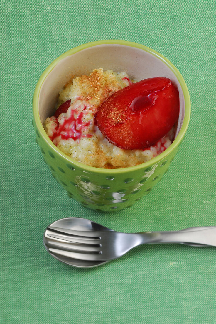 Bowl of sencha tea flavoured rice pudding on green background