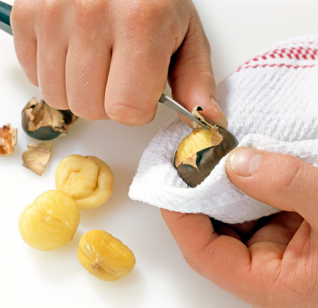 Chestnuts being peeled with knife, step 3