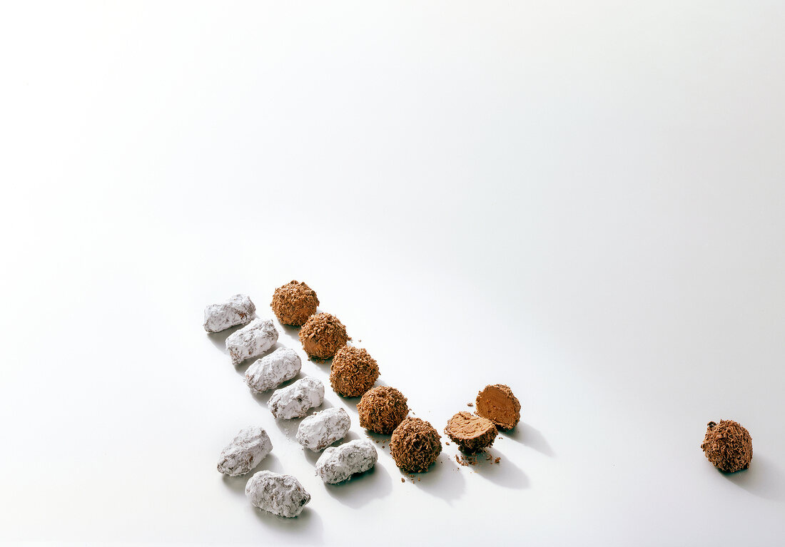 Coffee truffle and black forest truffle in a row on white background